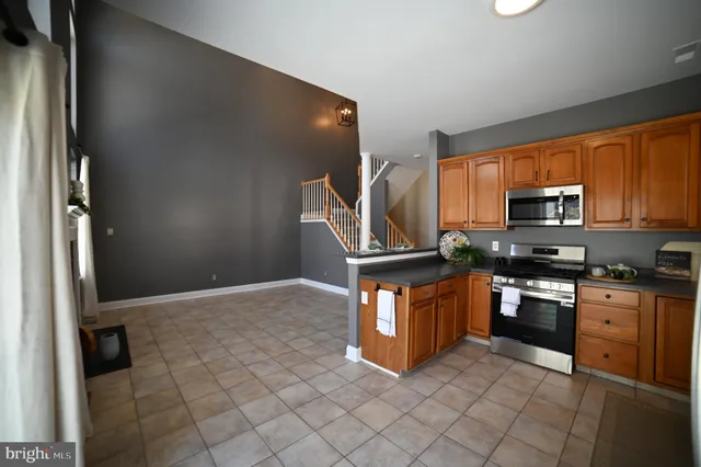 a kitchen with stainless steel appliances granite countertop a stove top oven a sink and dishwasher