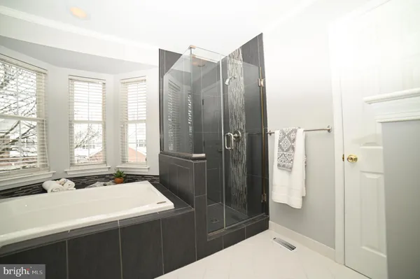 a bathroom with a shower and a sink