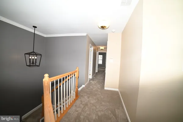 a view of a hallway with stairs