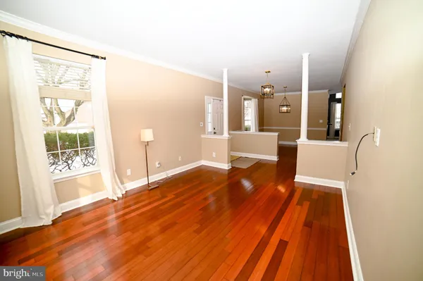 a spacious bedroom with a bed and wooden floor