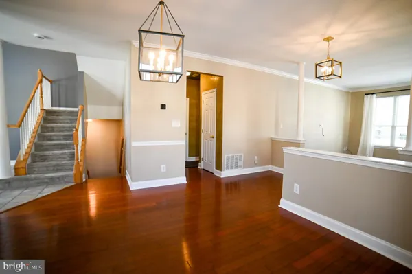 a view of a room with wooden floor and windows