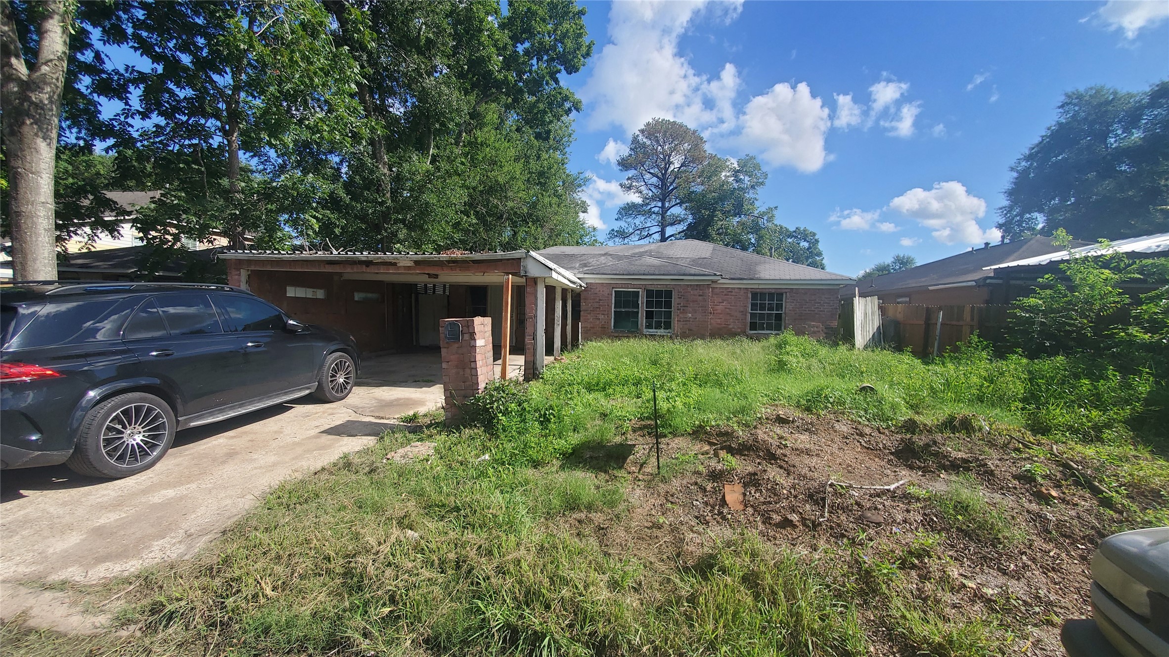 a view of a house with a cars park side of a road