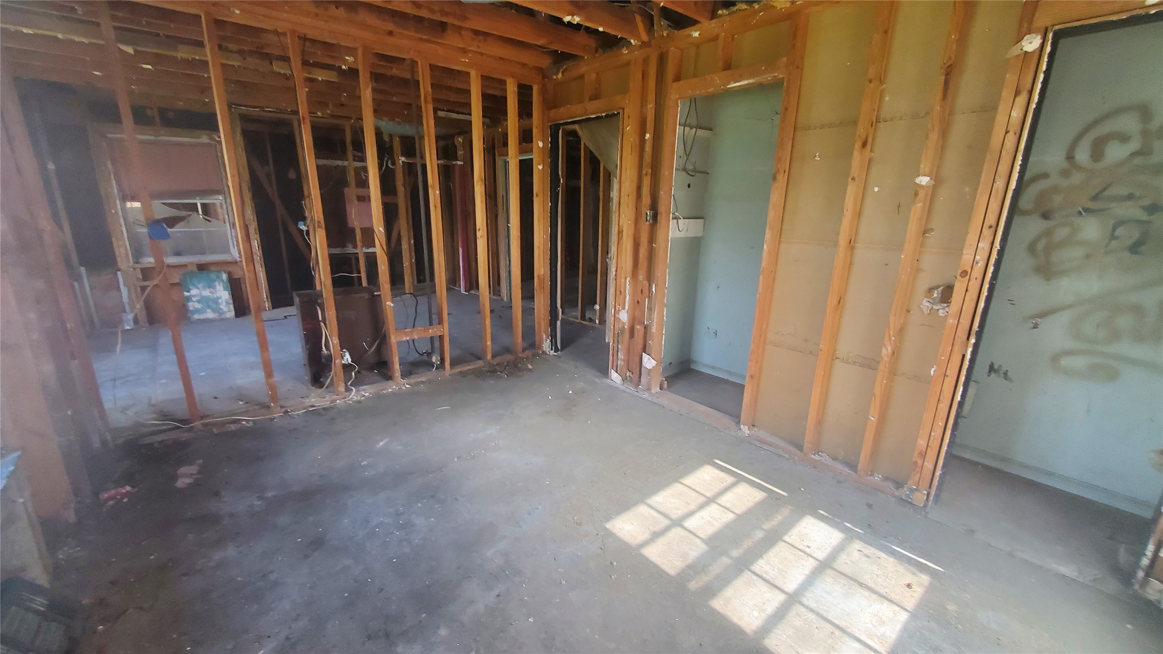4821 Burma Road Houston, TX 77033 - Photo 18 of 23 a view of empty room with wooden floor and fan
