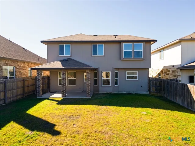 a front view of a house with a yard table and chairs
