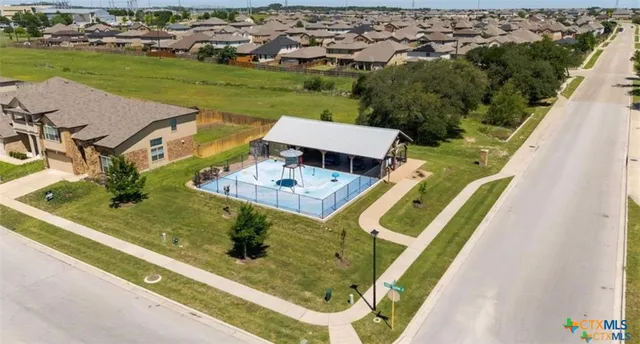 an aerial view of a house with a garden and pool
