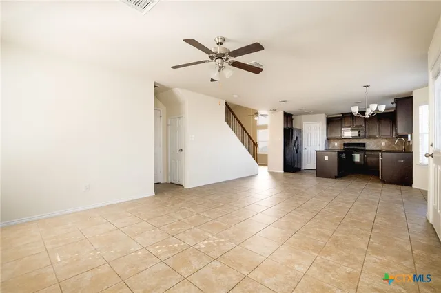 a view of a kitchen with a stove cabinets and ceiling fan