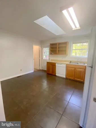 a view of a kitchen with a sink and cabinets