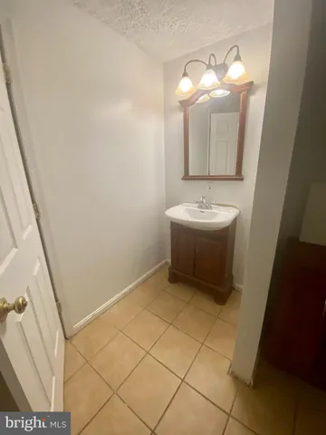a bathroom with a sink a mirror and a vanity