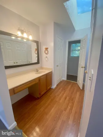 a spacious bathroom with a sink mirror and a bath tub