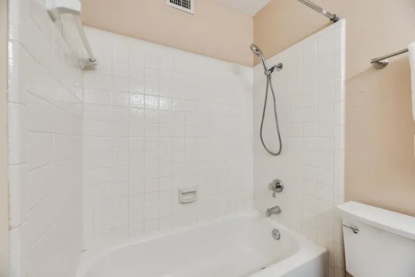 a bathroom with a bath tub with a shower