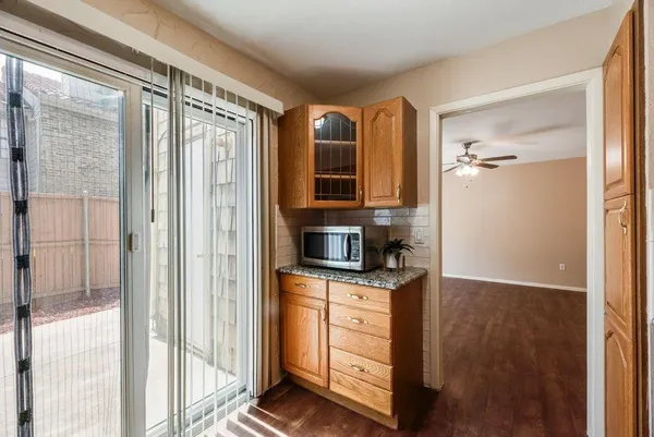 a view of kitchen with stainless steel appliances cabinets and outdoor view