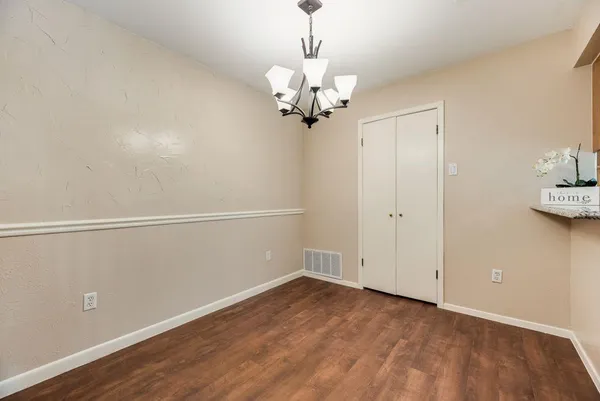 a view of a room with wooden floor