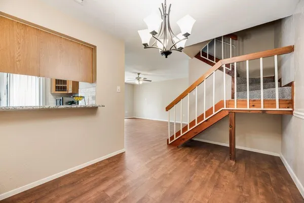 a view of staircase with white walls and a window