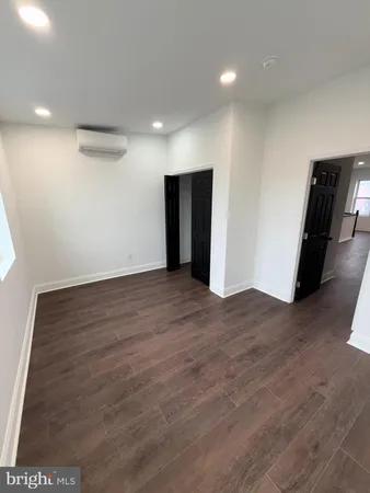 wooden floor in an empty room with a fireplace