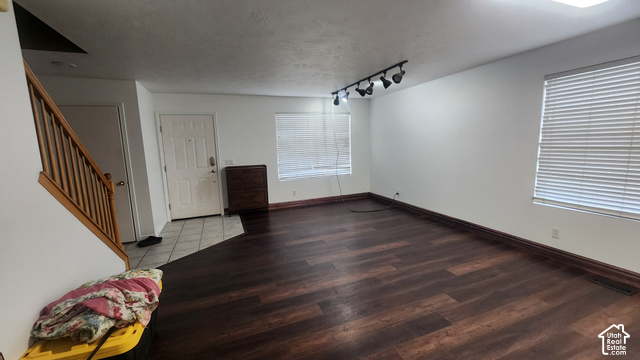 5948 Inheritance Court Taylorsville, UT 84123 - Photo 6 of 30 Wood-finish flooring throughout, white painted walls, natural wood staircase, two windows with blinds, and track lighting fixture