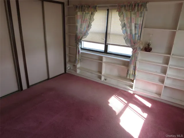 a view of an empty room with a fireplace