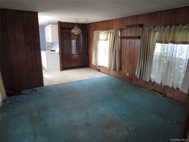 a view of empty room with wooden floor and cabinet