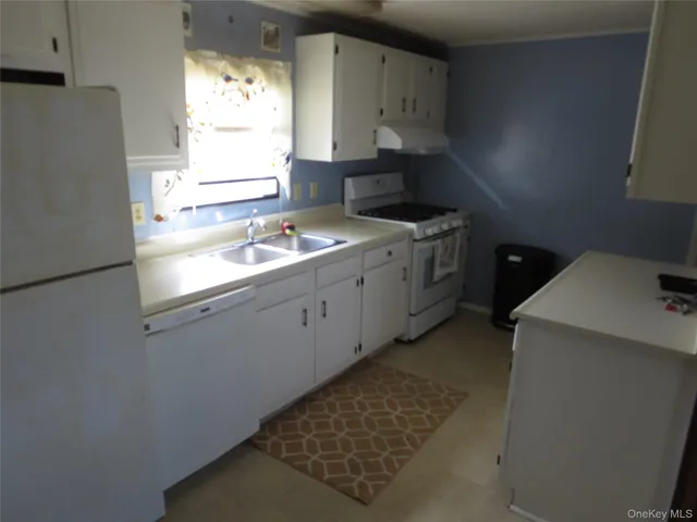 a kitchen with a sink stove and refrigerator