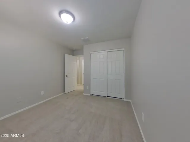 an empty room with a fan
