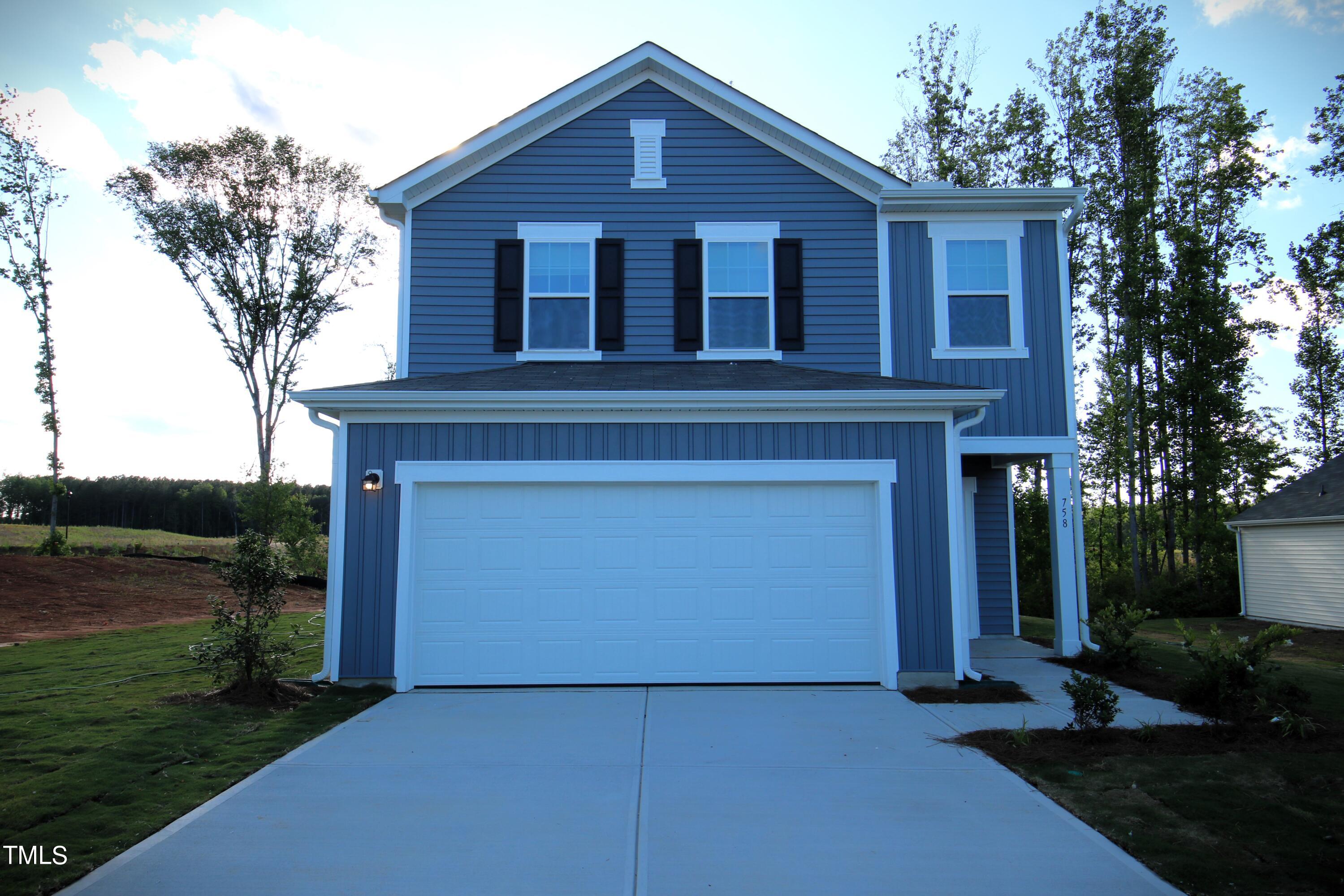 758 Piaggio Lane Spring Hope, NC 27882 - Photo 1 of 22 a front view of a house with garden