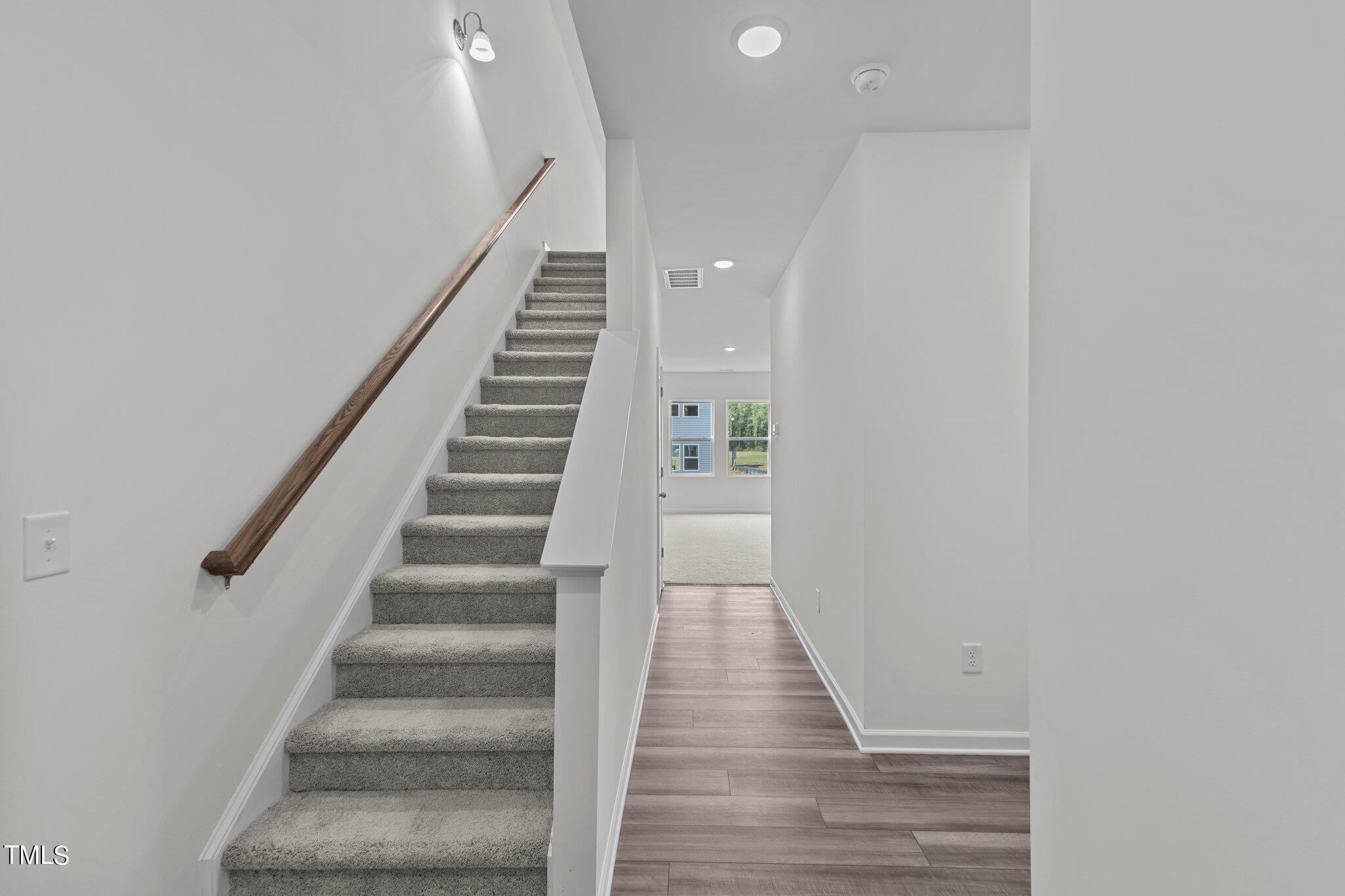 758 Piaggio Lane Spring Hope, NC 27882 - Photo 2 of 22 a view of staircase with wooden floor and white walls