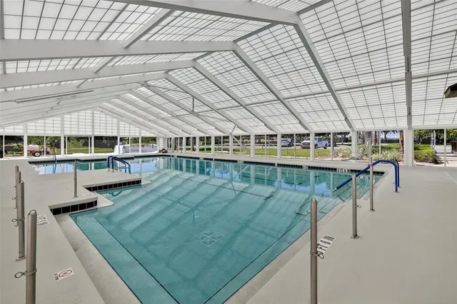 a view of swimming pool with outdoor seating and city view