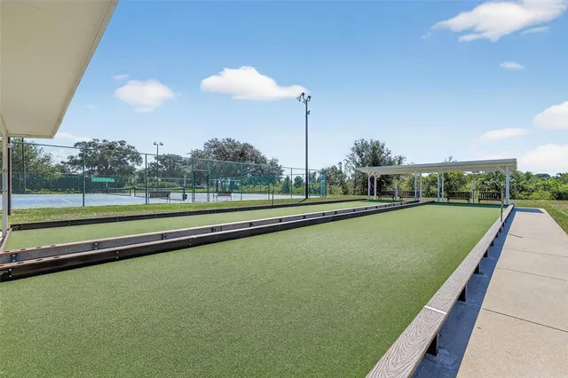 an aerial view of a tennis ground with a table and chairs