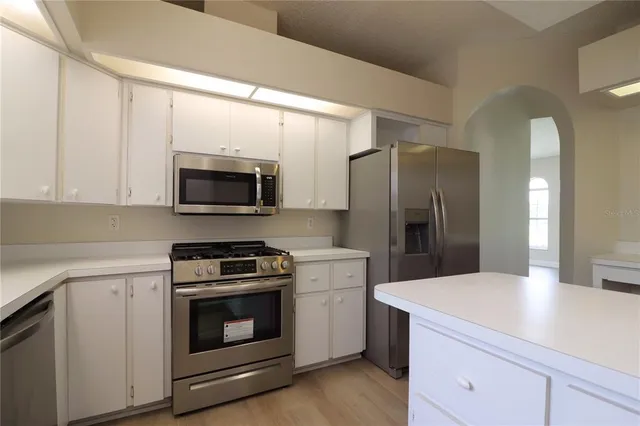 a kitchen with a stove and a microwave