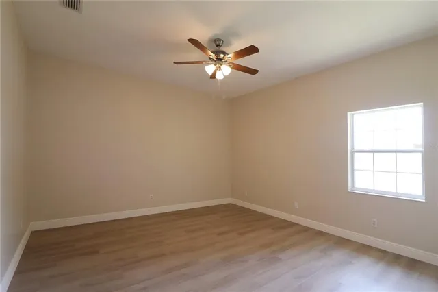 a view of a livingroom with a ceiling fan and window