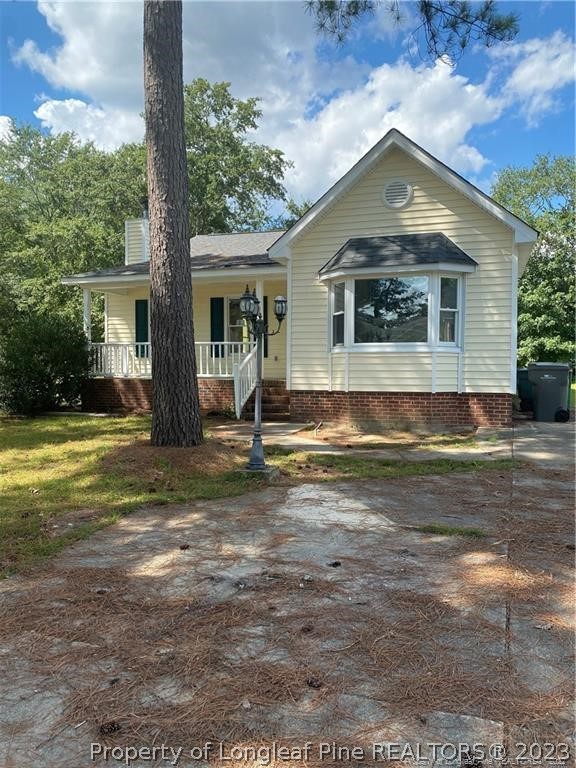 4324 Falls Drive Hope Mills, NC 28348 - Photo 1 of 10 a front view of a house with a yard