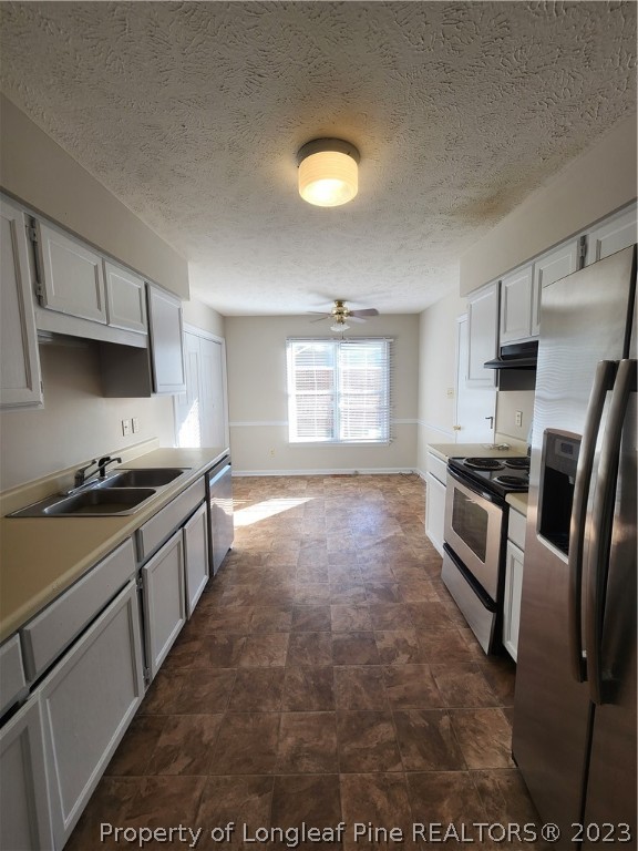 4324 Falls Drive Hope Mills, NC 28348 - Photo 3 of 10 a kitchen with stainless steel appliances granite countertop a stove a sink and a refrigerator
