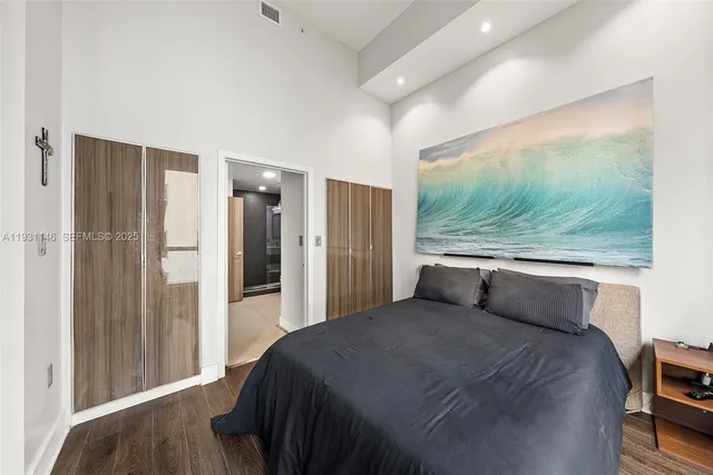 a bedroom with a bed and a large window