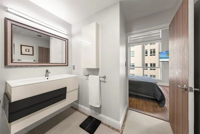 a bathroom with a sink a mirror and a shower