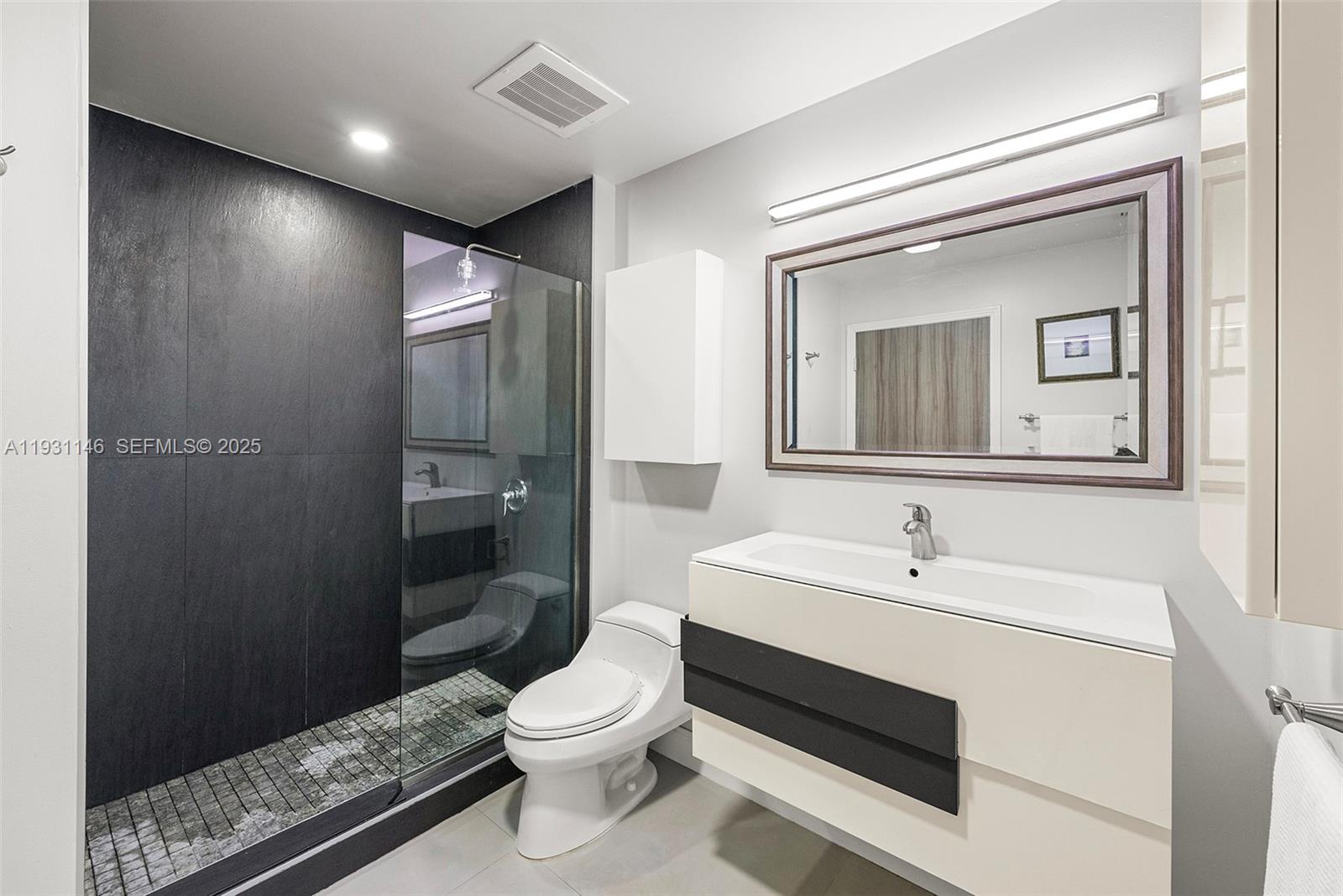 9066 Southwest 73rd Court, Unit 405 Miami, FL 33156 - Photo 15 of 32 a bathroom with a sink a toilet and shower