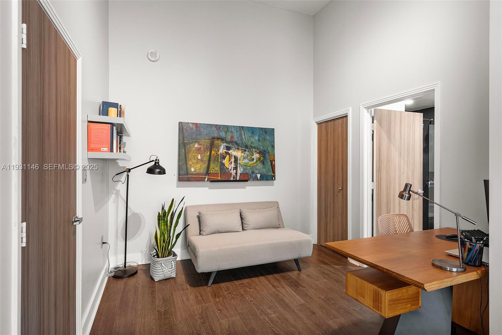 9066 Southwest 73rd Court, Unit 405 Miami, FL 33156 - Photo 17 of 32 a living room with furniture and a wooden floor