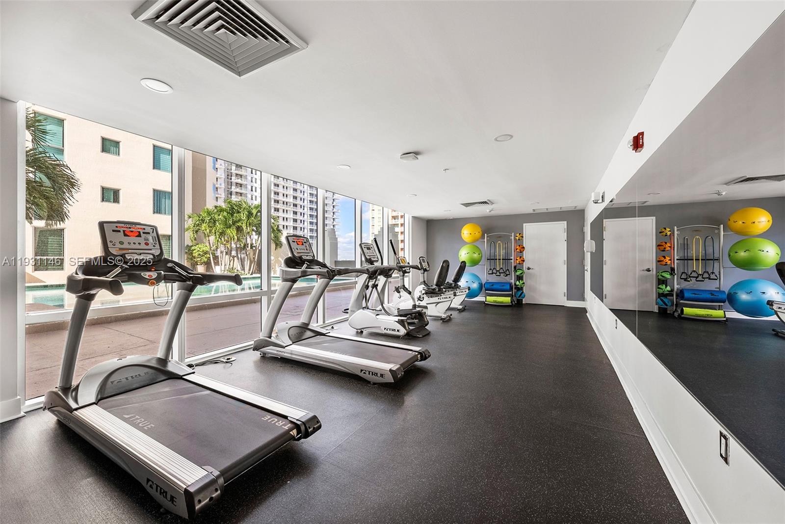 9066 Southwest 73rd Court, Unit 405 Miami, FL 33156 - Photo 26 of 32 a view of a room with gym equipment