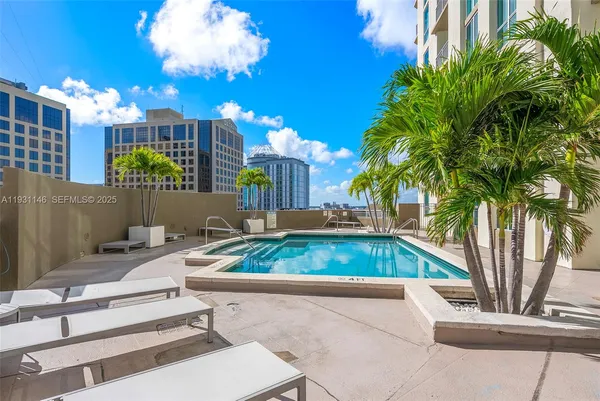 a view of a swimming pool with a lounge chair