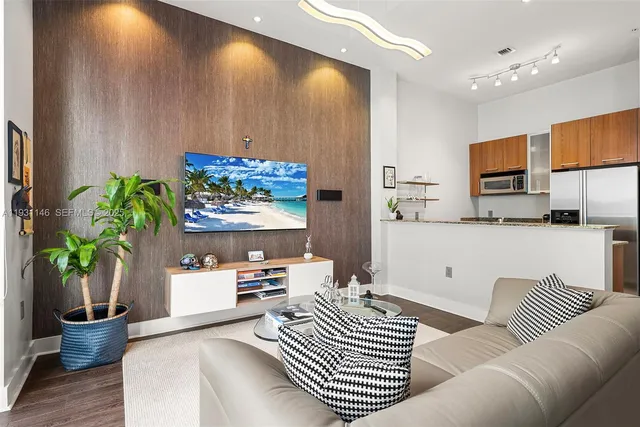 a living room with furniture and a potted plant