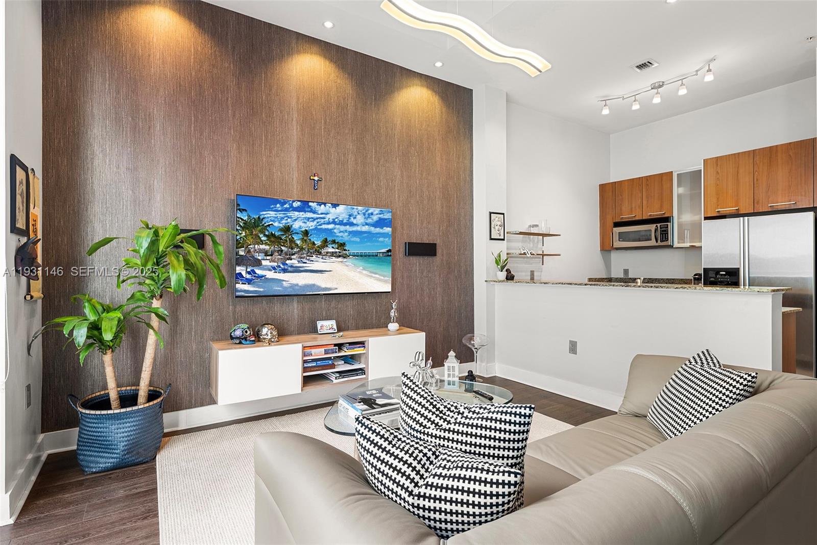 9066 Southwest 73rd Court, Unit 405 Miami, FL 33156 - Photo 4 of 32 a living room with furniture and a potted plant