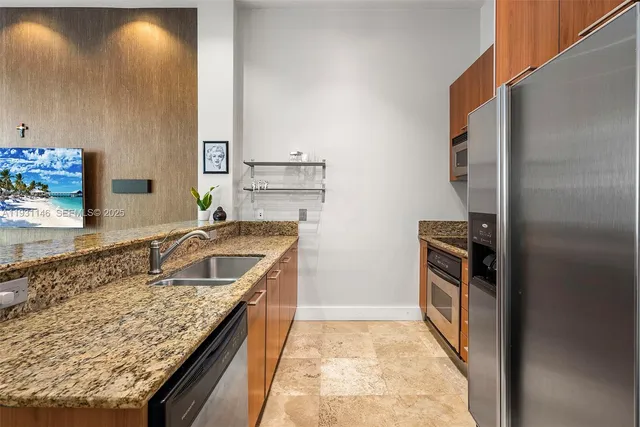 a kitchen with a sink stove and refrigerator