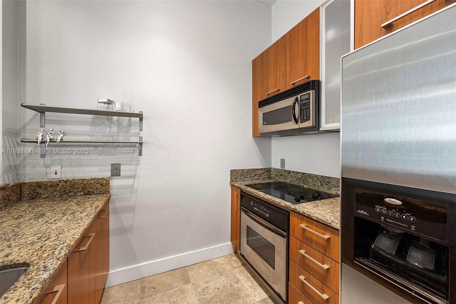 9066 Southwest 73rd Court, Unit 405 Miami, FL 33156 - Photo 7 of 32 a kitchen with granite countertop a stove and a microwave