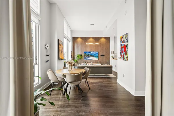 a dining room with furniture and wooden floor