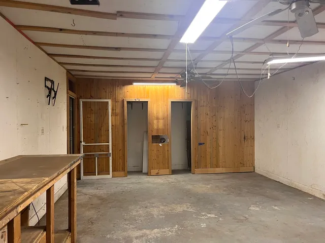 a view of empty room with wooden walls