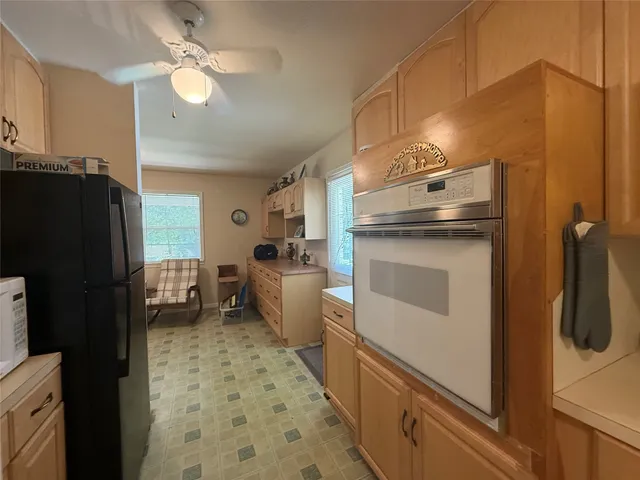 a kitchen with a refrigerator and a sink