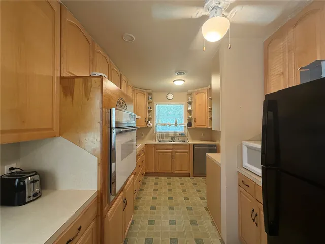 a kitchen with a refrigerator and cabinets