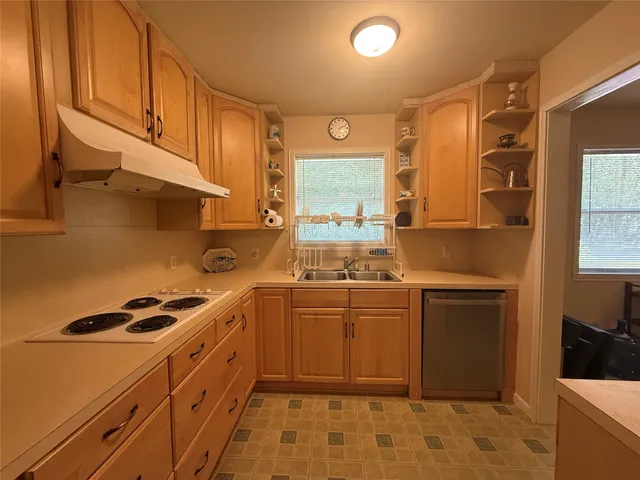 a kitchen with cabinets appliances and a counter space
