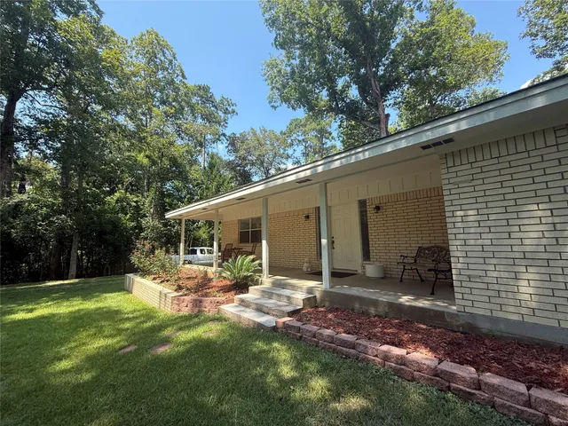 a backyard of a house with yard and outdoor seating