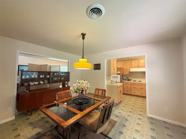 a kitchen with a table and chairs