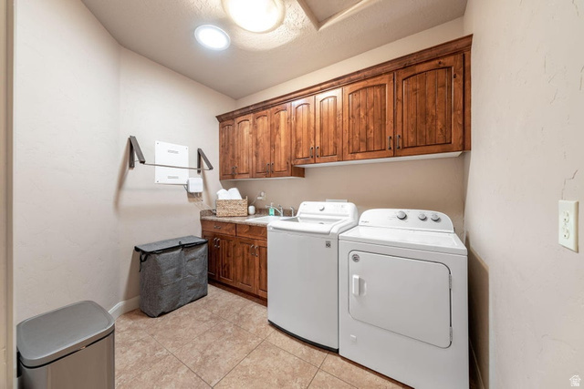 1609 East 10 S Street St. George, UT 84790 - Photo 25 of 68 Dedicated laundry room featuring rich wood cabinetry, a built-in utility sink, and tile flooring