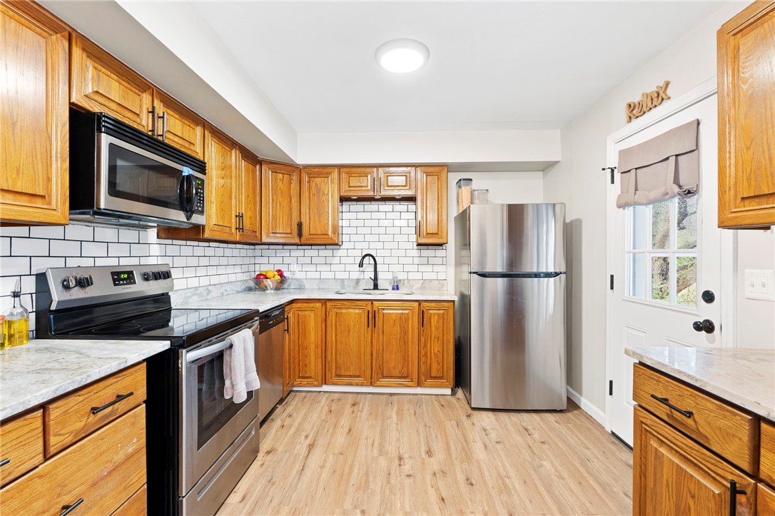 8180 Manning Road Germantown, OH 45327 - Photo 8 of 39 This bright kitchen features wood cabinetry and modern appliances, perfect for everyday living.